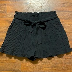 Black pleated high-waisted paper bag shorts